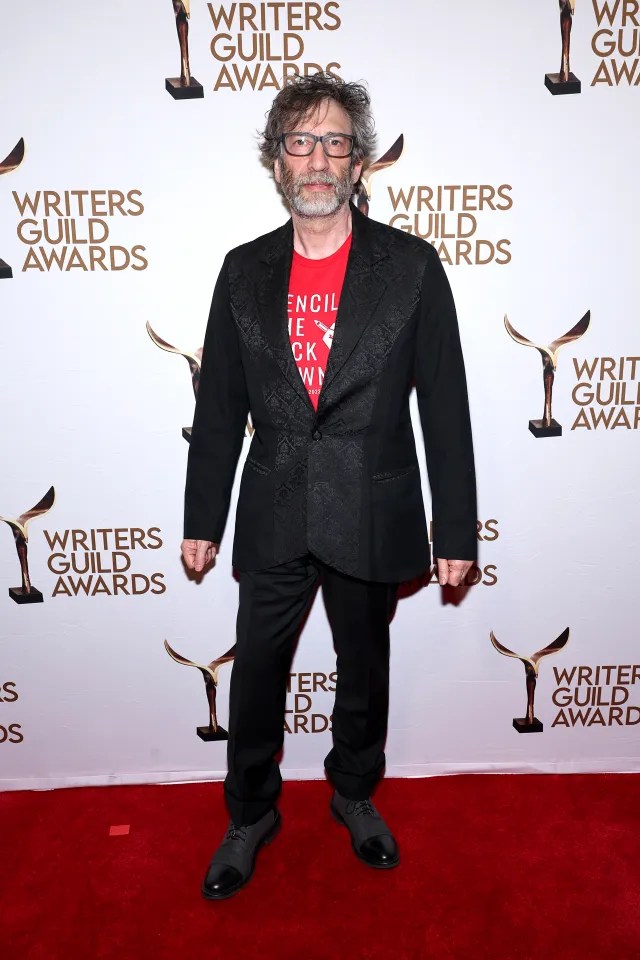 Man in suit at Writers Guild Awards.