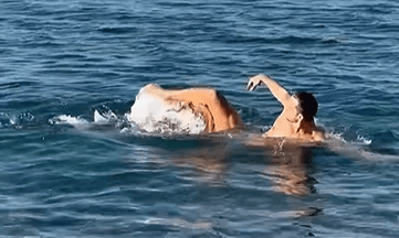 Man swimming in the ocean.