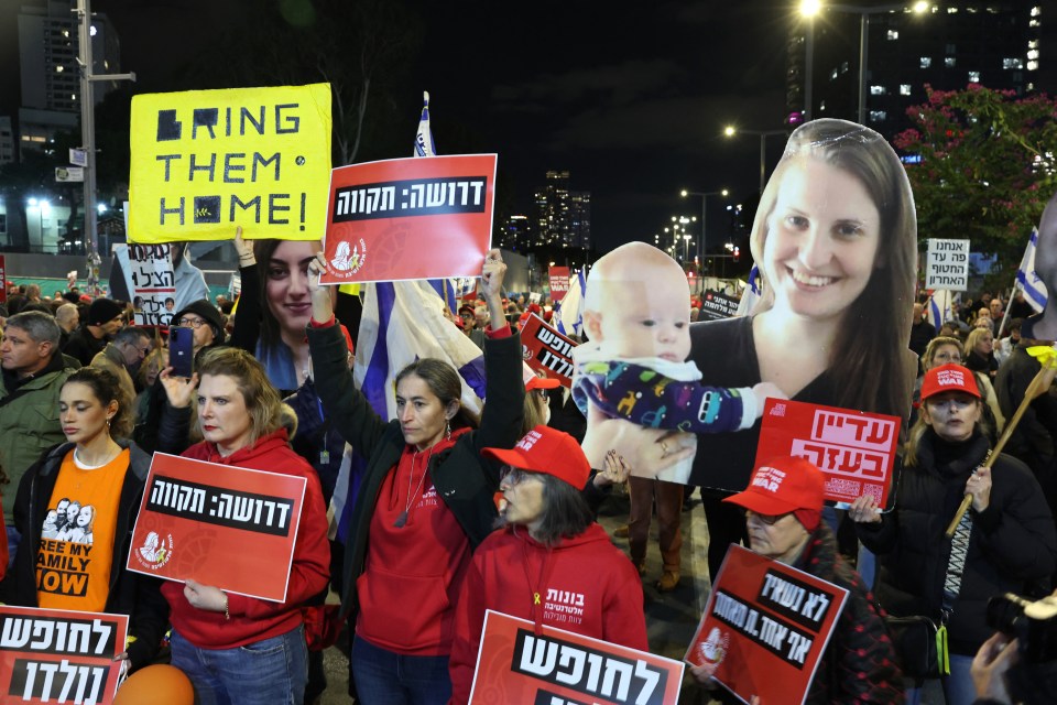 Protestors holding signs that say "Bring them home!" in English and Hebrew.