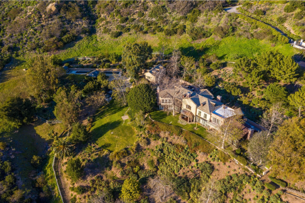 Aerial view of a large house and surrounding property.