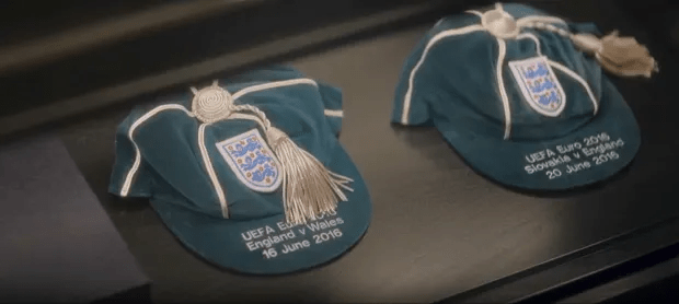 Two England football caps commemorating the UEFA Euro 2016 matches against Wales and Slovakia.