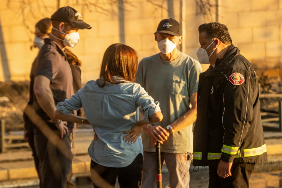 Group of people wearing masks talking outdoors.