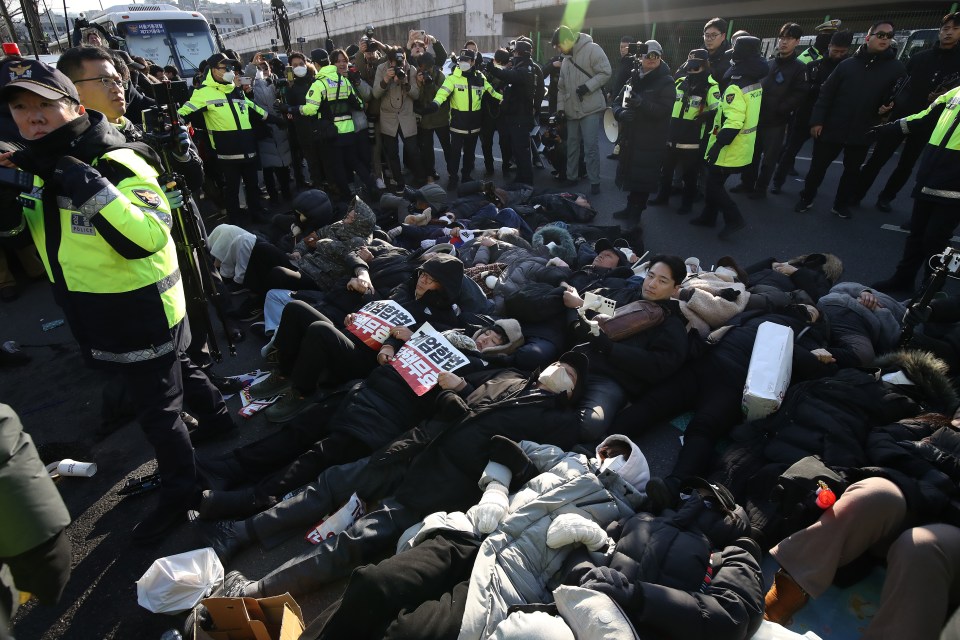 Protestors lying on the ground during a demonstration.