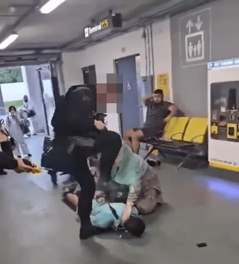 Police officers arresting a person on the ground.