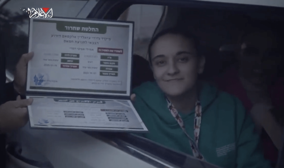 A girl in a car receives a certificate.