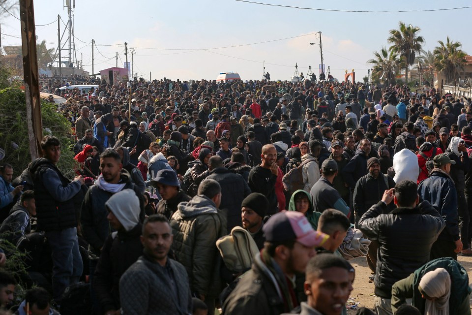 Large crowd of people gathered outdoors.