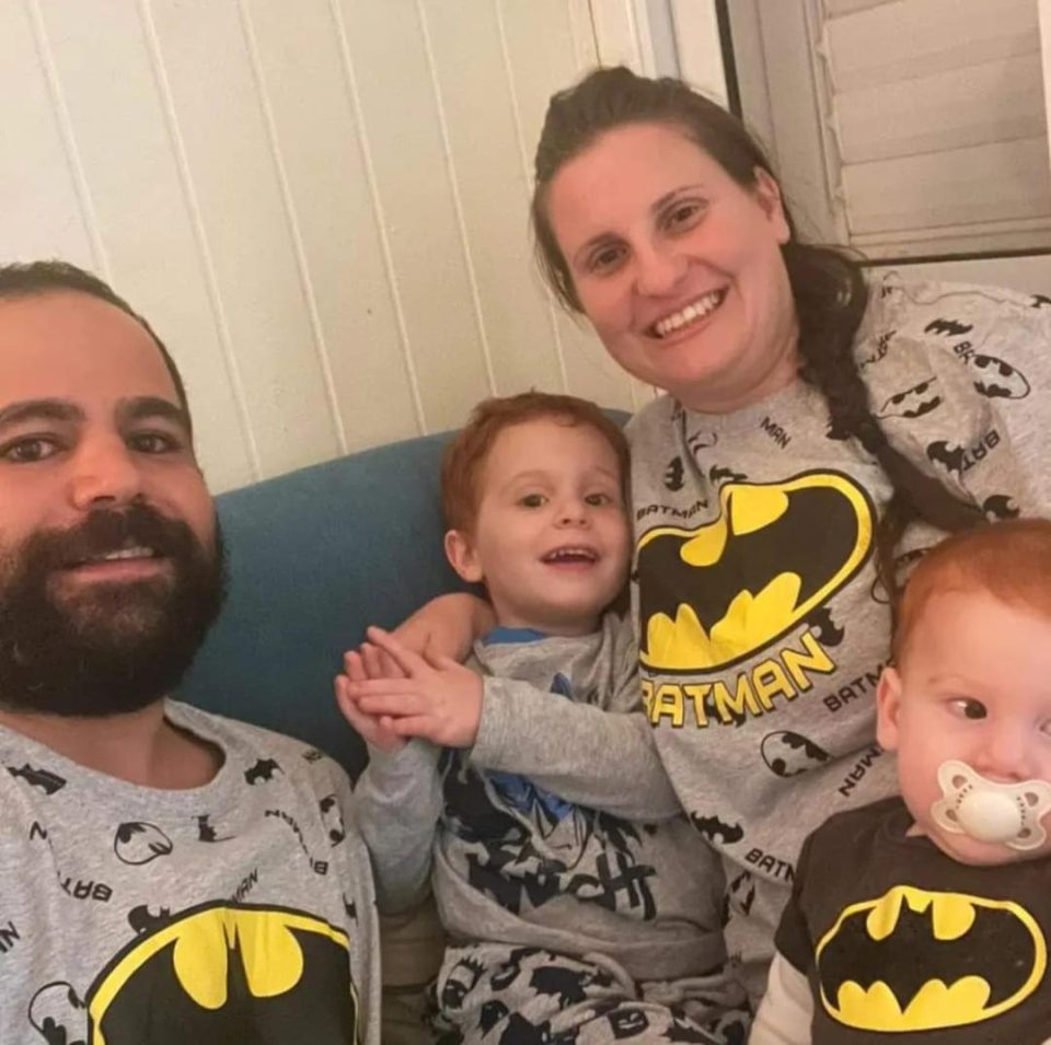 Family in matching Batman pajamas.