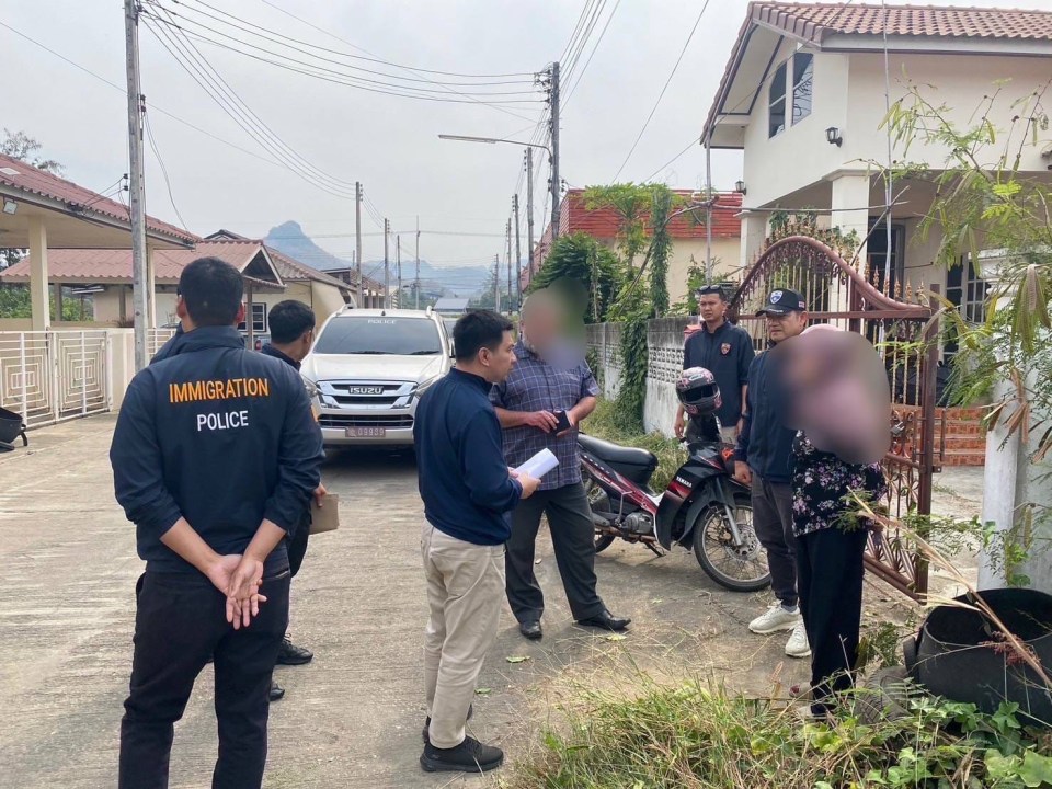 Immigration police officers at a residential home in Thailand.