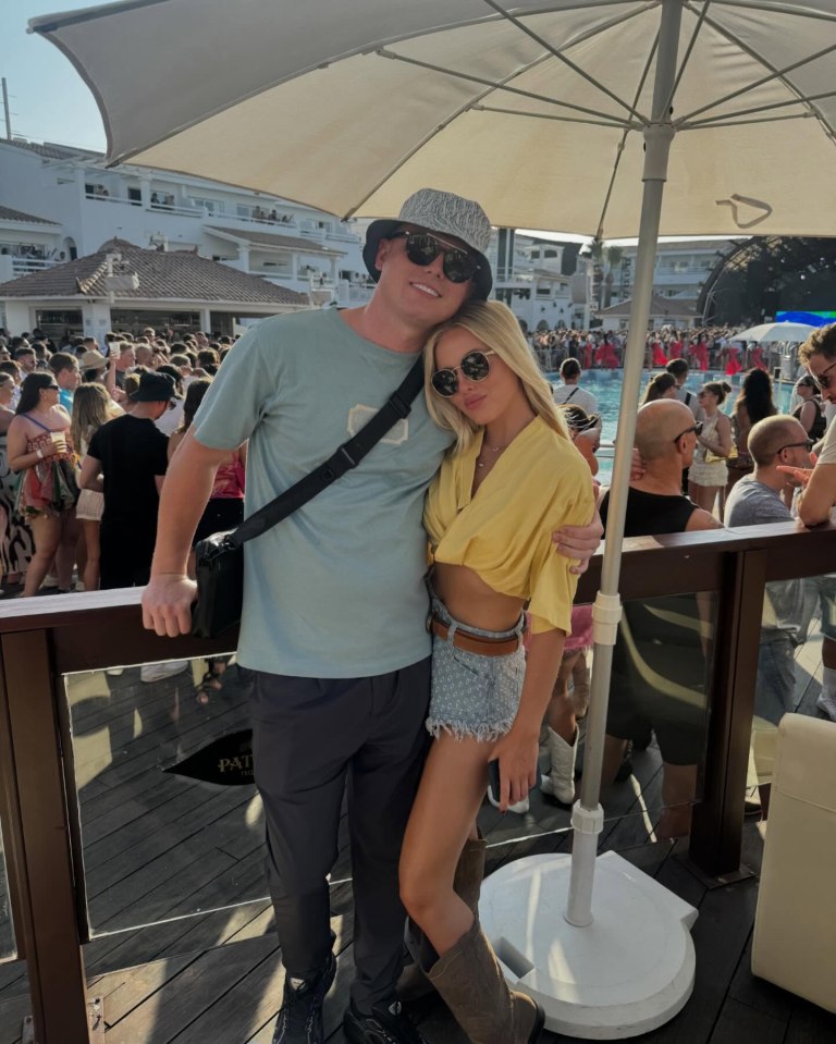 Couple posing for a photo at a pool party.