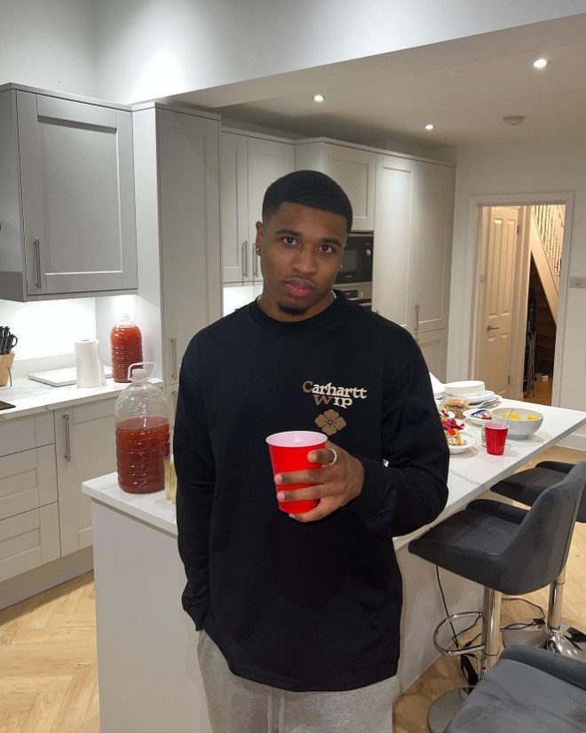 Montel McKenzie in his kitchen holding a red cup.