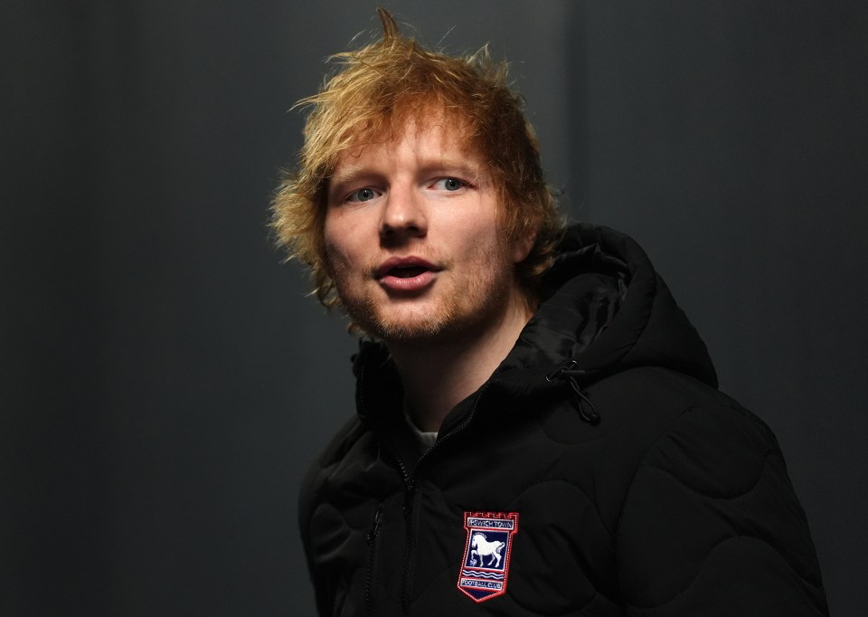 Ed Sheeran wearing an Ipswich Town Football Club jacket.