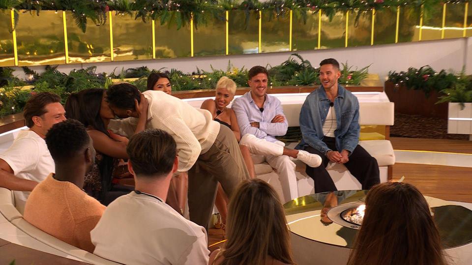 Love Island All Stars contestants kissing and watching others.