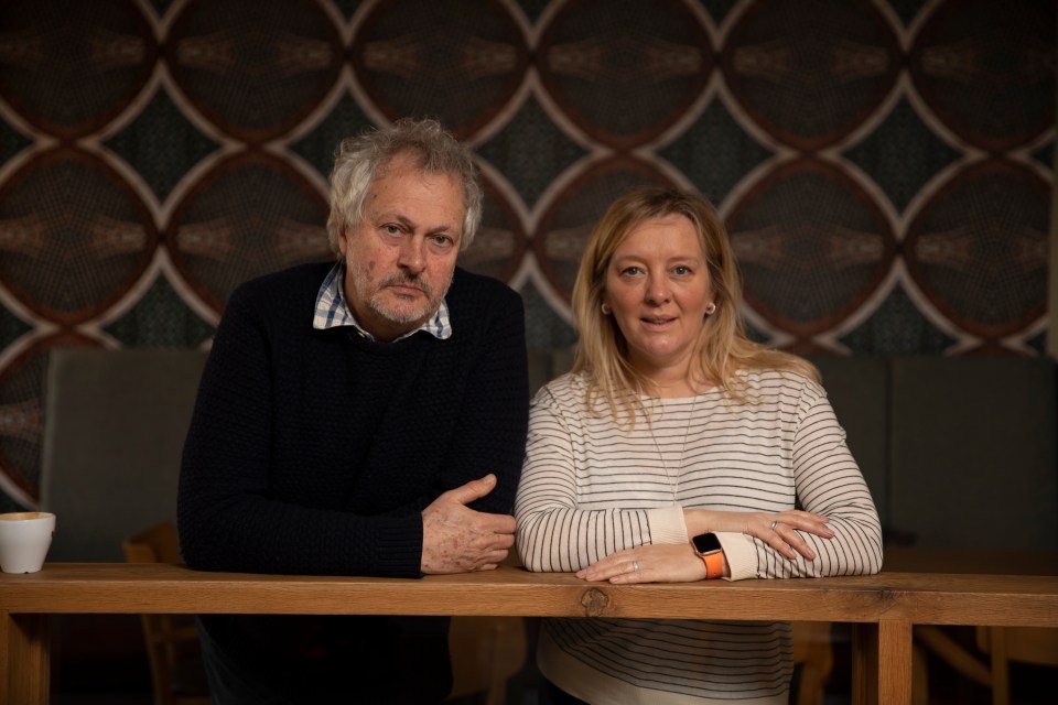 Portrait of a man and woman leaning on a wooden counter.