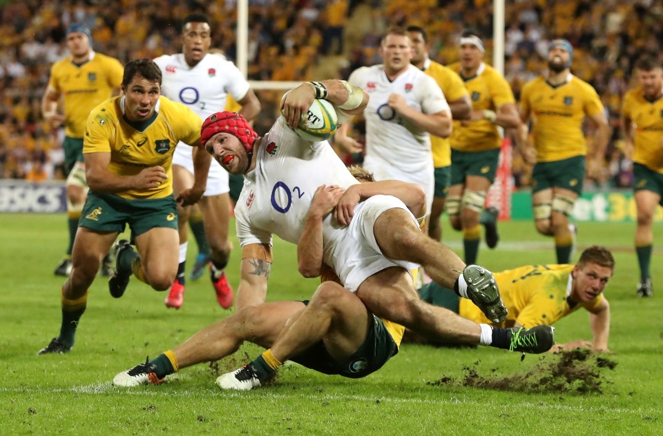 Rugby player tackled short of the try line.