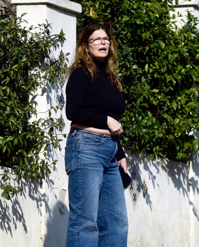 Jeanne Tripplehorn wearing a black sweater and jeans.