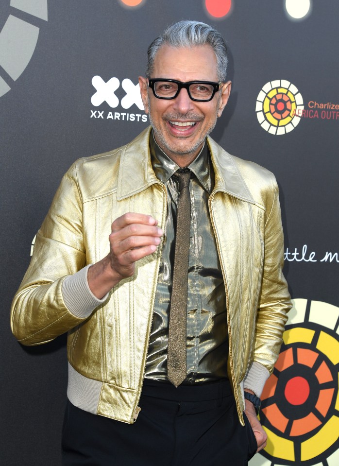 Jeff Goldblum at an event, wearing a gold jacket and shirt.