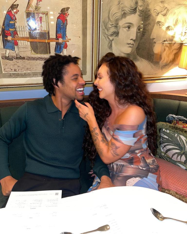 Jesy Nelson and her boyfriend laughing together at a restaurant.