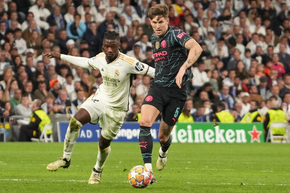 John Stones of Manchester City and Eduardo Camavinga of Real Madrid during a soccer match.