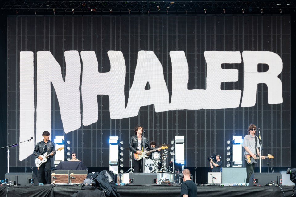 Inhaler performing on stage at a music festival.