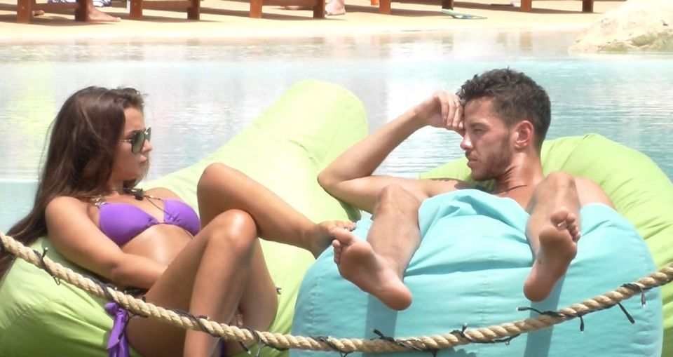 Kady McDermott and Scott Thomas relaxing by a pool.