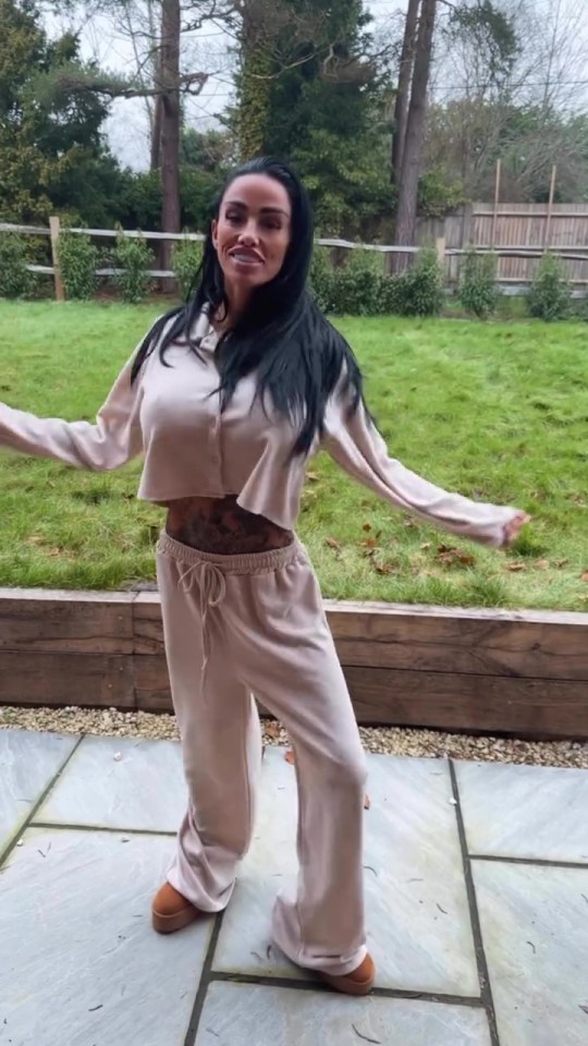 Katie Price showing off her tattooed stomach in a cropped tracksuit.