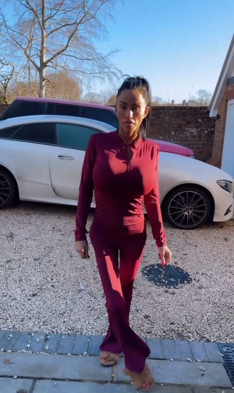 Katie Price in a burgundy tracksuit.