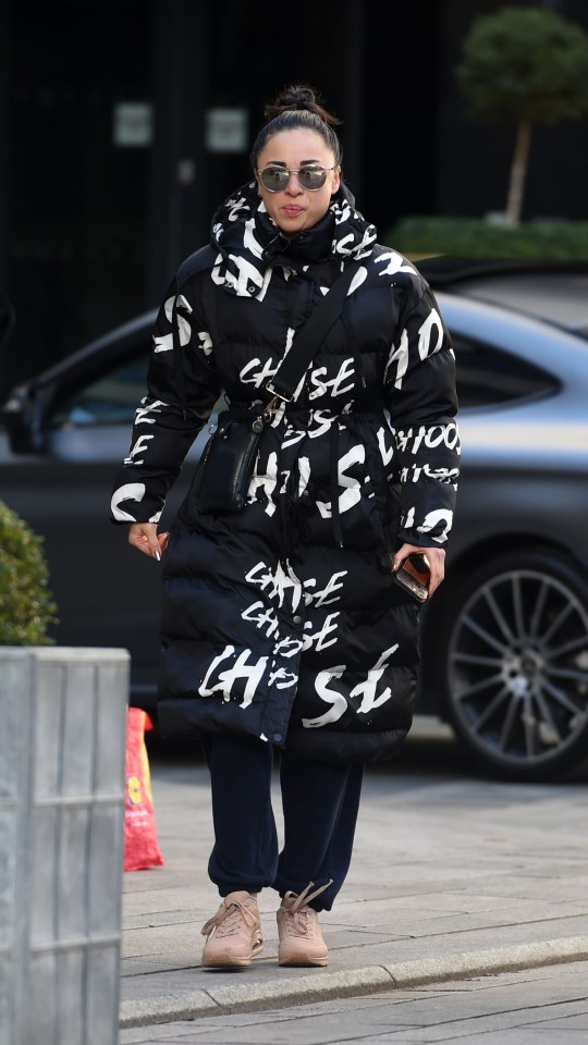 Katya Jones walking in Leeds wearing a black and white jacket.