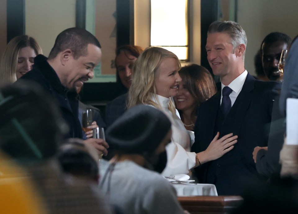 Kelli Giddish and Peter Scanavino sharing a kiss on the set of Law and Order: Special Victims Unit.