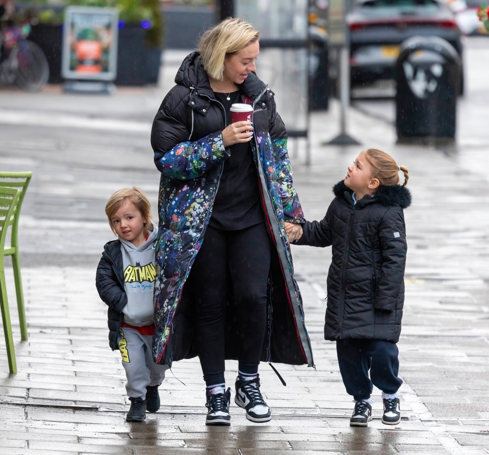 Kelsey Parker walking with her two children.