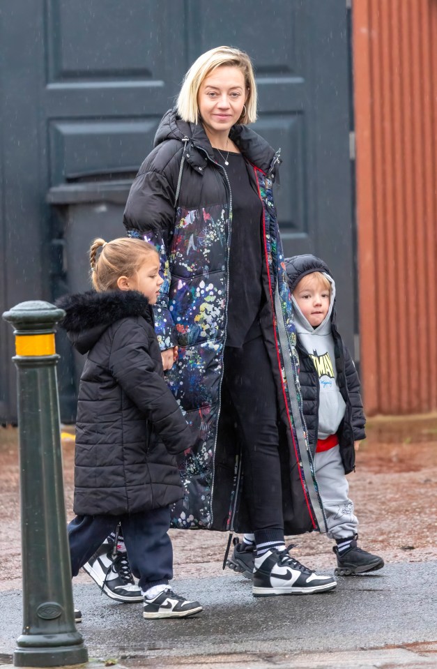 Kelsey Parker walking with her two children.