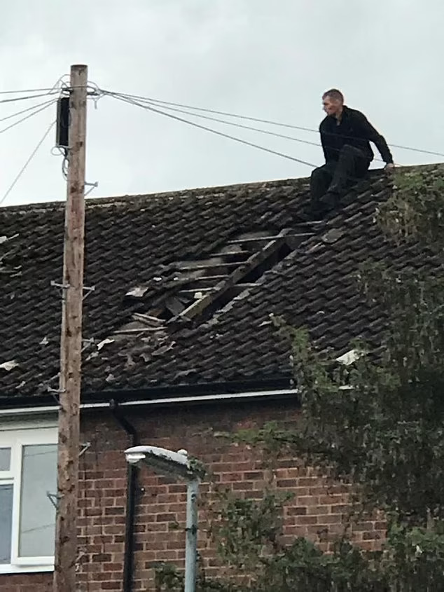 Man on damaged roof.