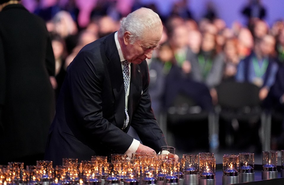 King Charles III lighting candles at Auschwitz-Birkenau.