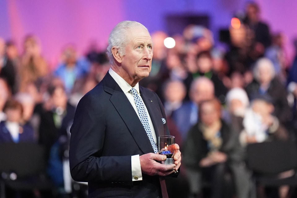 King Charles III lighting a candle at Auschwitz-Birkenau.