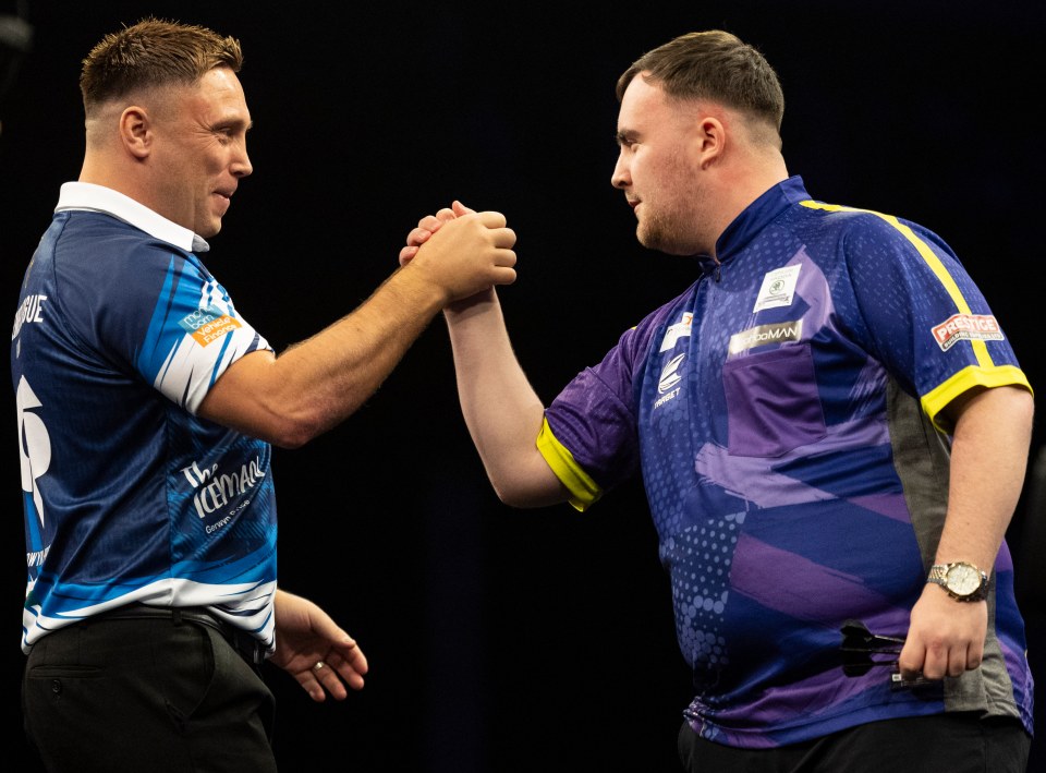 Gerwyn Price and Luke Littler shaking hands at a darts match.