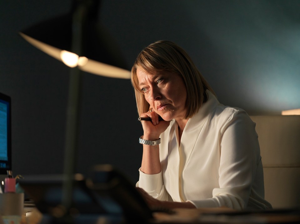 Nicola Walker as Hannah, working at her desk.