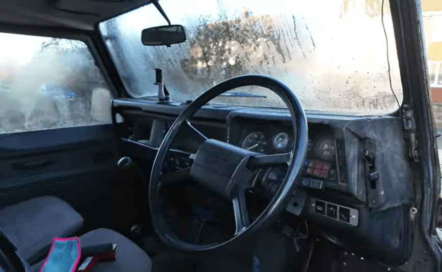 Interior view of a Land Rover Defender with fogged windows.