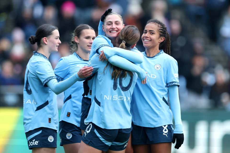 Manchester City women's soccer team celebrating a goal.