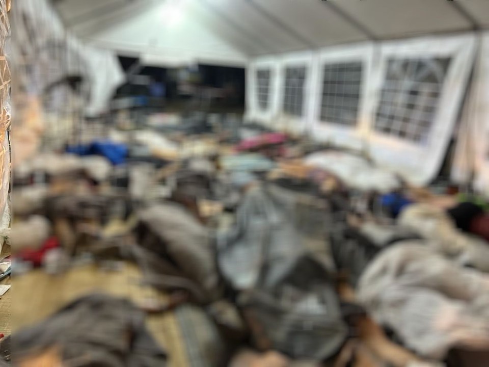 a blurred image of a room with a white tent