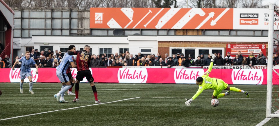 Soccer player scoring a goal.