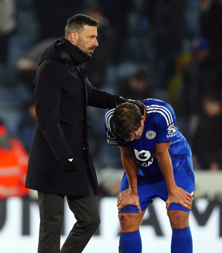 Leicester City manager consoling a player.