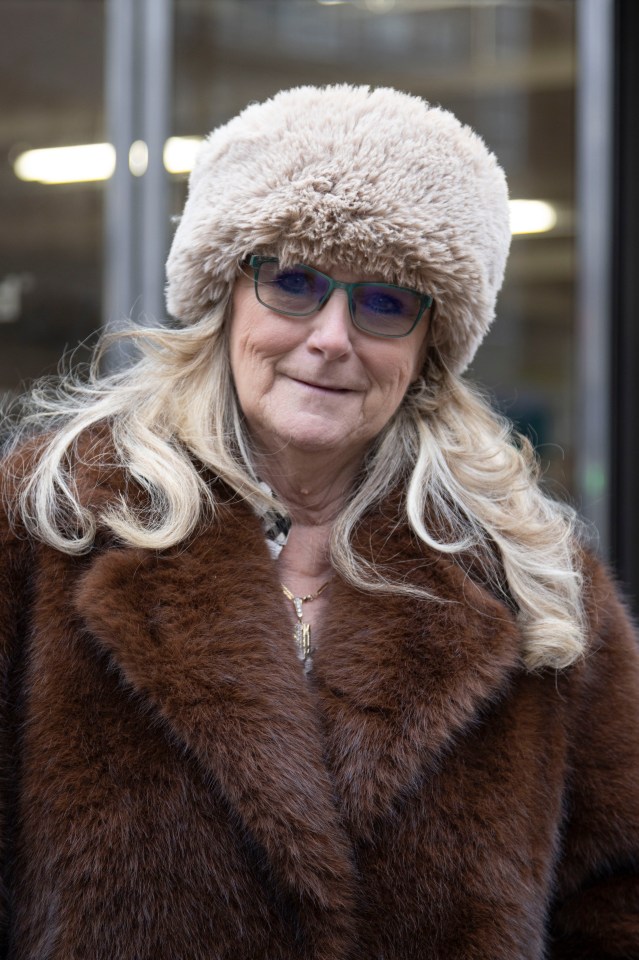 Woman in brown fur coat and beige fur hat.