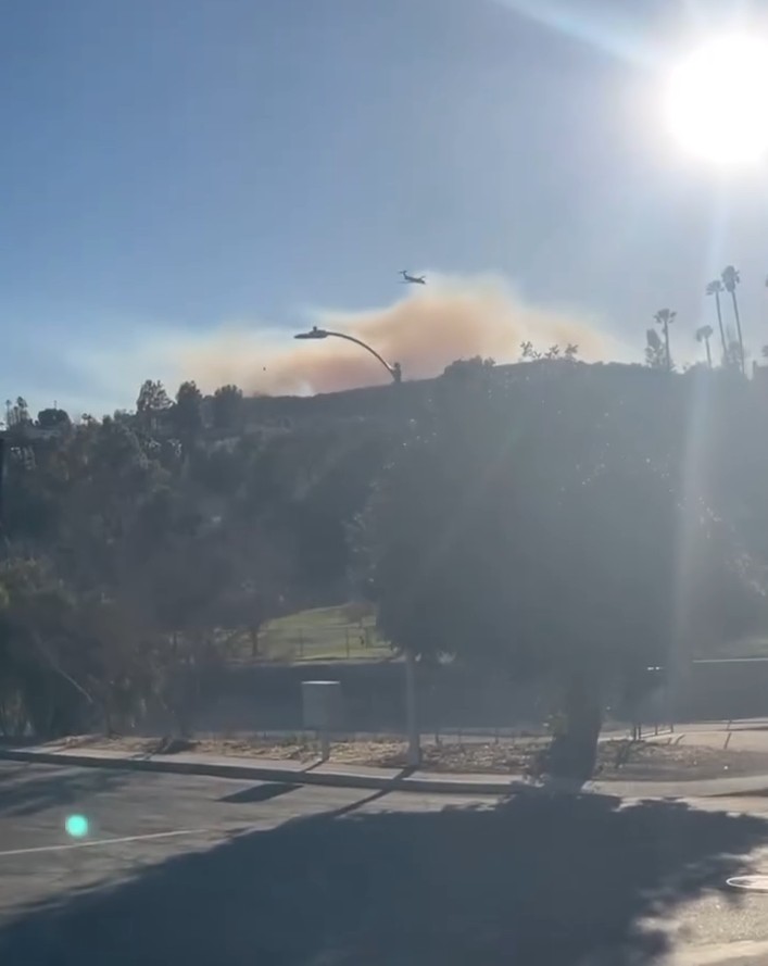 Wildfire with aircraft overhead.