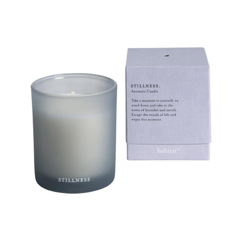 Stillness aromatic candle in gray glass jar and box.