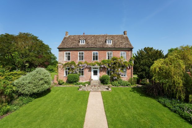 Brick manor house with wisteria.