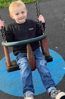 Young boy on a swing.