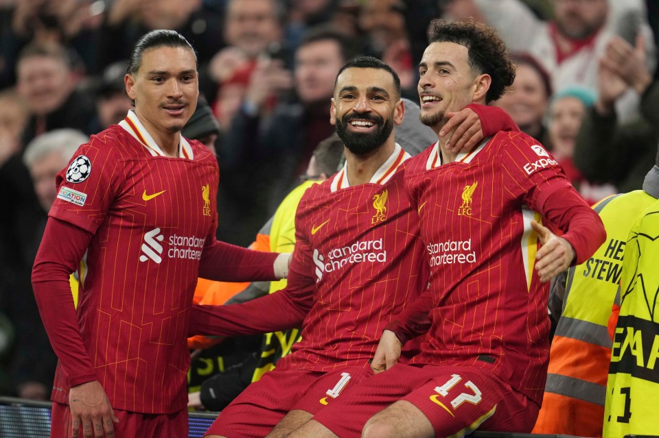 Mohamed Salah celebrating with teammates after scoring a goal.