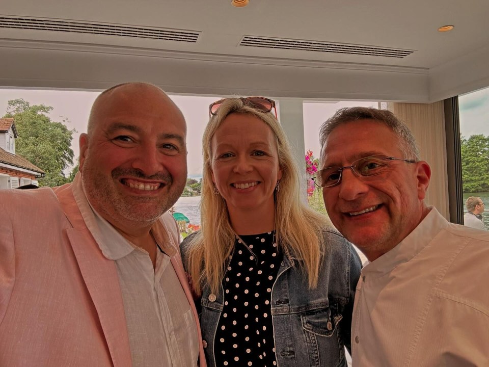 Three people smiling for a selfie.