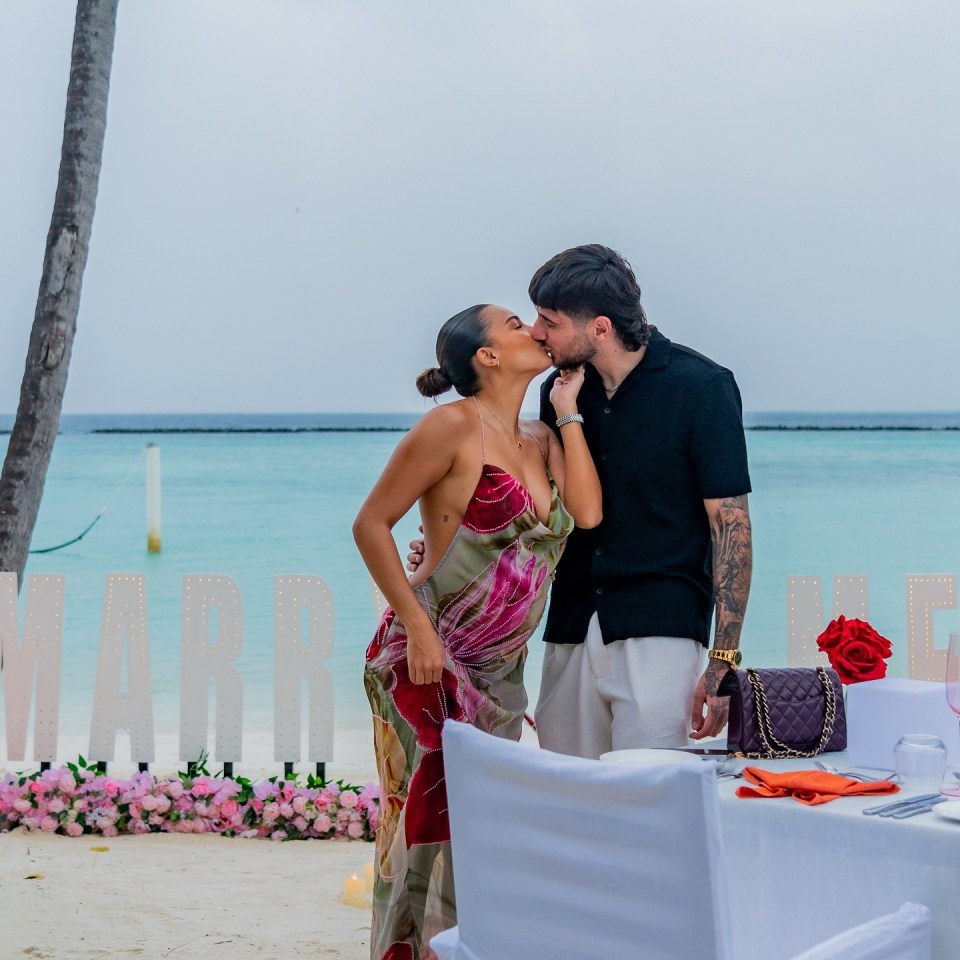 The couple shared a kiss on the  beach