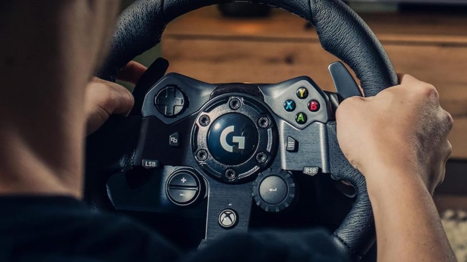 Person using a Logitech G923 racing wheel.