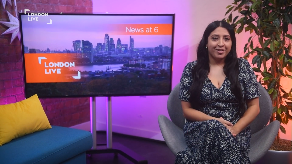 A woman sits in a chair in front of a screen showing the London Live News at 6.